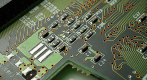 SMD components and vias on a green PCB